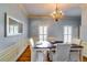 Traditional dining room with a wooden table, chandelier, and ample natural light at 965 Sundew Se Dr, Conyers, GA 30013