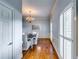 Bright dining room with hardwood floors, chandelier, wainscoting, and natural light at 965 Sundew Se Dr, Conyers, GA 30013