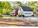 Beautiful view of this home with a long driveway, manicured lawn, a detached garage, and a lovely front porch at 965 Sundew Se Dr, Conyers, GA 30013