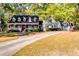 Charming home with dormer windows, inviting front porch, and long driveway leading to a detached garage at 965 Sundew Se Dr, Conyers, GA 30013