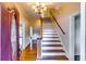 Bright foyer with hardwood floors, an elegant staircase, and a view of the living spaces beyond at 965 Sundew Se Dr, Conyers, GA 30013