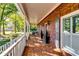 Inviting brick front porch with decorative columns, a ceiling fan, and outdoor seating area at 965 Sundew Se Dr, Conyers, GA 30013