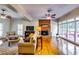 Spacious living room with a brick fireplace, hardwood floors, and ample natural light at 965 Sundew Se Dr, Conyers, GA 30013