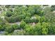 Stunning aerial view of a home nestled within a lush, green canopy of trees, providing both privacy and natural beauty at 2482 Windchase Ct, Buford, GA 30518