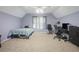 Large bedroom featuring a bed, two windows, and a desk area at 2482 Windchase Ct, Buford, GA 30518