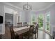 Dining room featuring hardwood floors, a wooden table with seating for six, and bay windows at 2482 Windchase Ct, Buford, GA 30518