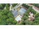 Aerial view showcases community amenities including pool, tennis courts, and playground surrounded by lush greenery at 2482 Windchase Dr, Buford, GA 30518