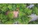 Aerial view of a private home surrounded by lush landscaping and green trees at 2482 Windchase Dr, Buford, GA 30518