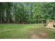 Large backyard area highlighting the well-maintained lawn and mature trees in the distance at 2482 Windchase Dr, Buford, GA 30518