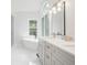 Bright, updated bathroom with a freestanding tub, a window, and modern fixtures at 2482 Windchase Dr, Buford, GA 30518