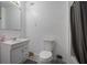 Clean, bright bathroom featuring a modern sink, vanity, toilet, and shower with gray curtain at 2482 Windchase Dr, Buford, GA 30518