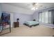 Large bedroom with a ceiling fan, window, bed with a striped cover and a basketball hoop at 2482 Windchase Dr, Buford, GA 30518