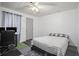 Cozy bedroom with natural light, carpeted floors, a ceiling fan and a comfortable bed at 2482 Windchase Dr, Buford, GA 30518