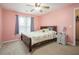 Cozy bedroom with a soft bed, pink walls, carpet and a window covered with curtains at 2482 Windchase Dr, Buford, GA 30518