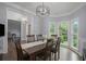 Elegant dining room with hardwood floors, wainscoting, and plenty of natural light at 2482 Windchase Dr, Buford, GA 30518
