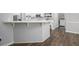 Kitchen view showing hardwood floors, white cabinets, and white counter bar at 2482 Windchase Dr, Buford, GA 30518