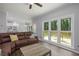 Bright living room with hardwood floors, large windows, and access to the deck at 2482 Windchase Dr, Buford, GA 30518