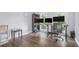 Spacious office featuring a modern desk setup with multiple monitors and stylish hardwood floors at 2482 Windchase Dr, Buford, GA 30518