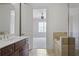 Bathroom featuring tiled tub, vanity, and doorway to bedroom at 326 Roswell Se St # 508, Marietta, GA 30060