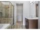 Beautiful bathroom featuring a glass shower, dark vanity, and tile flooring at 326 Roswell Se St # 508, Marietta, GA 30060
