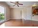 Empty room with hardwood floors, white trim, neutral paint, sliding glass doors to a balcony and view to kitchen at 326 Roswell Se St # 508, Marietta, GA 30060