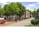 Beautiful brick building with a cozy outdoor seating area surrounded by lush trees, creating a serene ambiance at 326 Roswell Se St # 508, Marietta, GA 30060