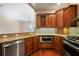 Updated kitchen with stainless steel appliances, granite countertops, and custom cabinetry with a wine rack at 326 Roswell Se St # 508, Marietta, GA 30060
