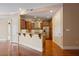 Modern kitchen featuring stainless steel appliances, brown cabinetry, granite countertops, and bar seating at 326 Roswell Se St # 508, Marietta, GA 30060