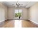 Spacious living room featuring hardwood floors, neutral walls, modern ceiling fan, and a balcony for natural light at 326 Roswell Se St # 508, Marietta, GA 30060