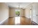 Bright and airy living room with hardwood floors, neutral walls, and a sliding glass door that leads to a balcony at 326 Roswell Se St # 508, Marietta, GA 30060