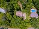 Aerial view of home showcasing lush landscaping, surrounding greenery, swimming pool, and neighborhood at 9041 Par Dr, Douglasville, GA 30134