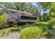 Beautifully landscaped backyard featuring a screened porch and deck perfect for outdoor relaxation at 9041 Par Dr, Douglasville, GA 30134