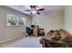 Bedroom has a desk with a computer and printer, a futon, and a large window for natural light at 9041 Par Dr, Douglasville, GA 30134