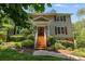 Charming two-story home with brick stairs, white railings, and manicured landscaping at 9041 Par Dr, Douglasville, GA 30134