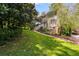 Manicured lawn and garden leading to two-story house with red shutters at 9041 Par Dr, Douglasville, GA 30134