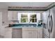 Well-lit kitchen showcasing a stainless steel refrigerator and double sink at 9041 Par Dr, Douglasville, GA 30134