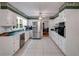 Bright kitchen featuring stainless steel appliances and tile flooring at 9041 Par Dr, Douglasville, GA 30134
