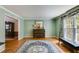 Bright, airy living room with hardwood floors, piano and large window at 9041 Par Dr, Douglasville, GA 30134