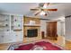 Cozy living room featuring a brick fireplace and built-in shelving at 9041 Par Dr, Douglasville, GA 30134
