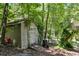 Backyard shed nestled amongst trees and greenery, with easy access from the yard at 9041 Par Dr, Douglasville, GA 30134