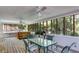Large screened in porch featuring a hot tub, table and chairs, ceiling fans, wood floors, and screened windows at 9041 Par Dr, Douglasville, GA 30134