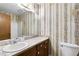 Bathroom with floral wallpaper and a marble vanity at 1909 Winding Creek Sw Ln, Marietta, GA 30064