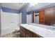 Bathroom with blue walls, a marble countertop, and a shower-tub combination at 1909 Winding Creek Sw Ln, Marietta, GA 30064