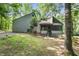 Home exterior featuring unique architectural design surrounded by mature trees and well-maintained lawn at 1909 Winding Creek Sw Ln, Marietta, GA 30064