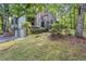 Exterior view of the home showing the 2-car garage and wooded surroundings at 1909 Winding Creek Sw Ln, Marietta, GA 30064