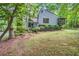 View of the house from the front yard surrounded by mature trees and landscaping at 1909 Winding Creek Sw Ln, Marietta, GA 30064