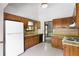 Kitchen featuring wood cabinets, laminate countertops, and a white refrigerator at 1909 Winding Creek Sw Ln, Marietta, GA 30064