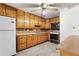 A kitchen featuring knotty pine cabinets, white refrigerator, and a ceiling fan with lights at 1909 Winding Creek Sw Ln, Marietta, GA 30064