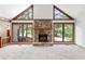 Living room with stone fireplace and large windows offering serene outdoor views at 1909 Winding Creek Sw Ln, Marietta, GA 30064