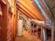 View of the attic with exposed beams, water heater, and ductwork at 625 Chestnut St # D, Atlanta, GA 30354